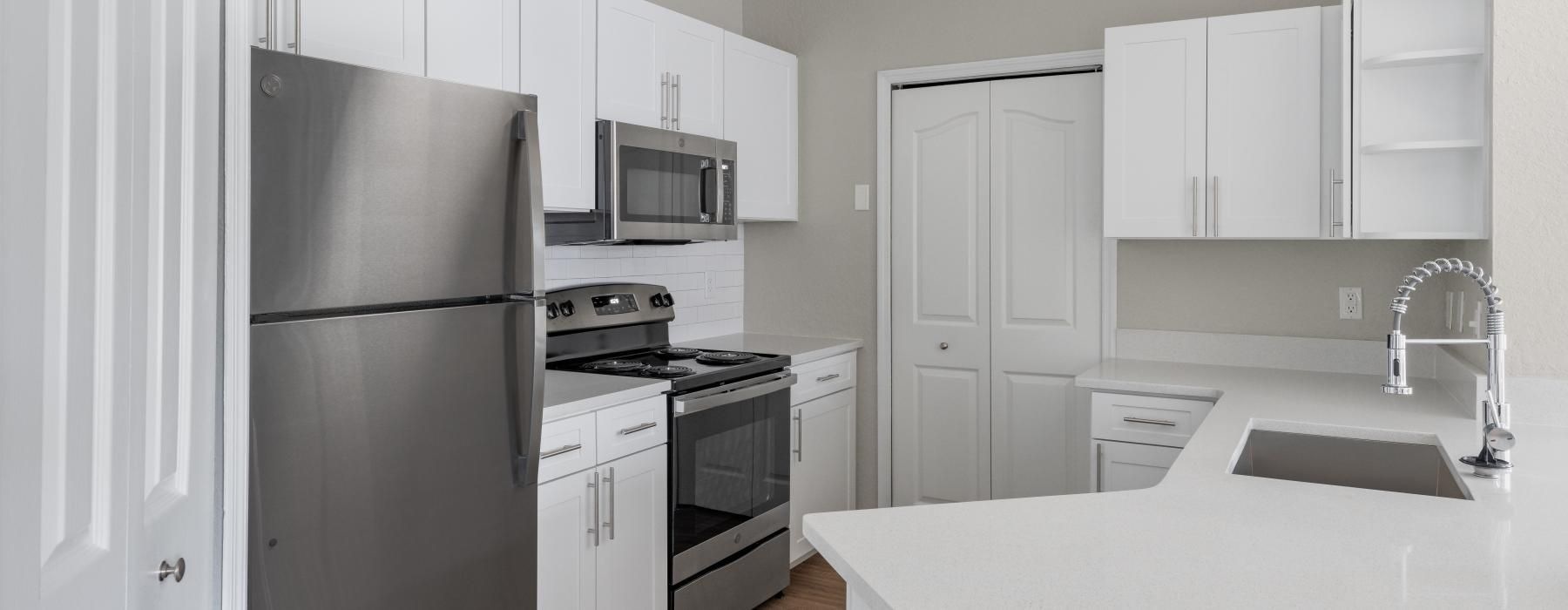 a kitchen with white cabinets