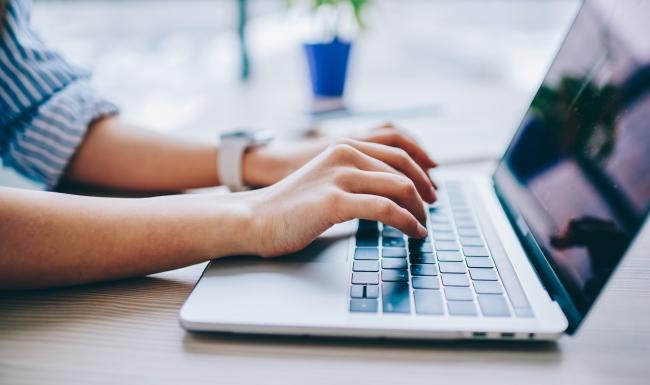 a person typing on a laptop