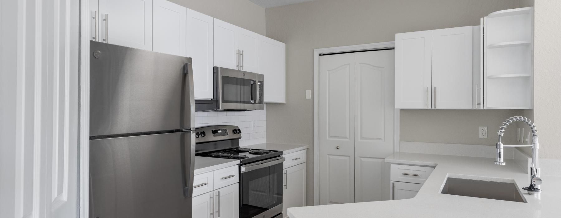 a kitchen with white cabinets